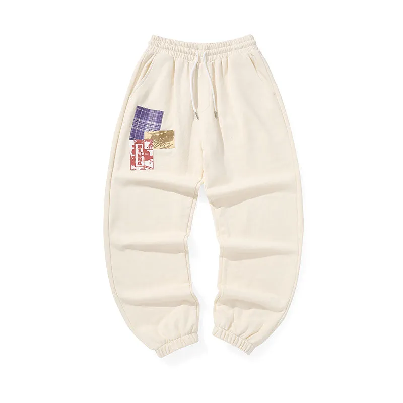 Cotton sweatpants with graffitied elastic mid-rise waist and loose legs