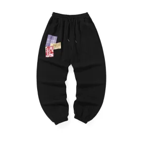 Cotton sweatpants with graffitied elastic mid-rise waist and loose legs